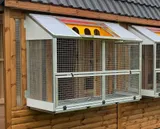 Aluminium trap mechanism on apex pigeon loft, close-up detail