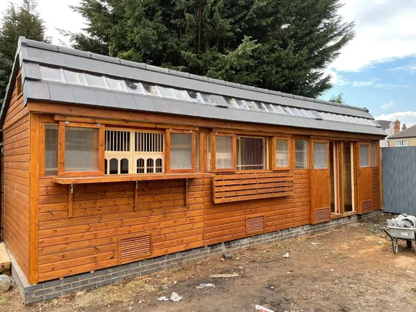 Castle Apex Pigeon Loft with decorative arched openings and mesh compartments on block base