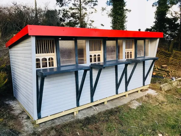 Castle Pent Pigeon Loft with arched trap openings and alternating white and dark panels