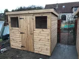 Classic pent timber shed with double doors and two windows, natural wood finish