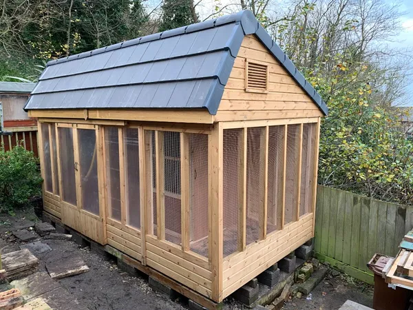 Heavy duty stock loft with tiled roof, showcasing the robust timber framing and wire mesh security