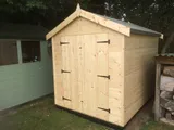 New natural timber apex garden shed with double doors and decorative finial