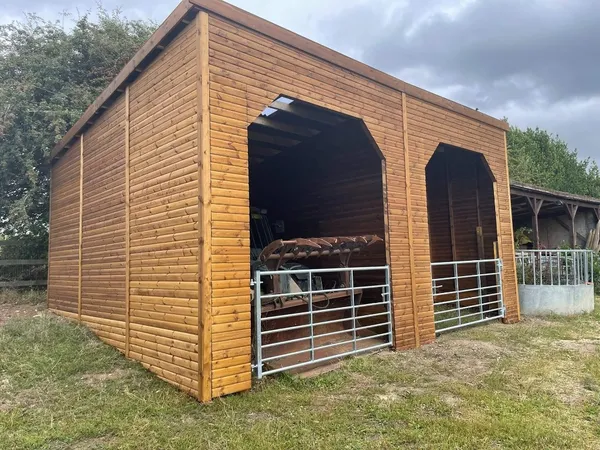 Agricultural timber barn with open tractor bay and high-clearance access