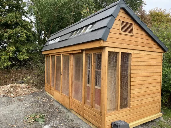 Side view of a tiled apex stock loft showing roof lights and the secure wire mesh layout