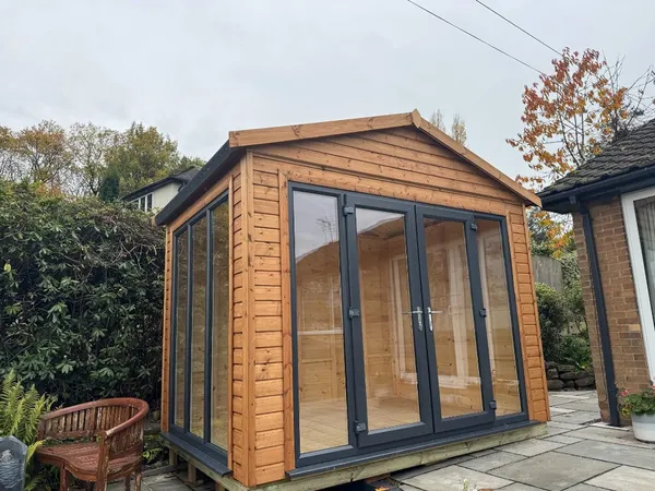 Angled exterior view of the Modern Apex garden room highlighting the roof overhang and premium timber cladding