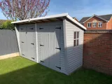 Custom-painted double garage with bespoke front canopy overhang and multi-pane side window