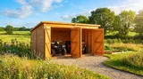 Utility garage with twin double doors open, housing two full-sized quad bikes side-by-side