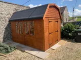 Dutch Barn shed with double doors, multi-pane windows and high-level gable window