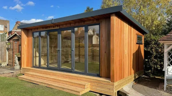 The Contemporary Executive Garden Office with anthracite grey UPVC French doors, full-height glass and integrated decking step