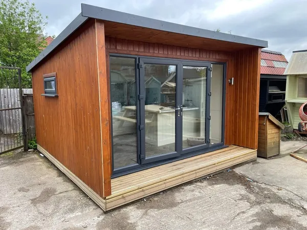 The Contemporary Executive Garden Office on lawn with pent roof overhang and premium timber cladding