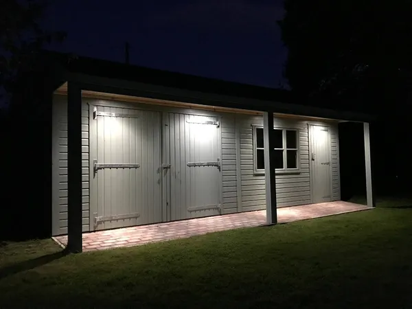 Structural front canopy illuminated by integrated downlights at night