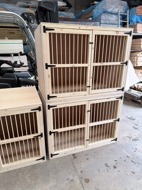 Kick boxes — double-tier and single-tier wooden nest units with slatted doors and black ironmongery in a workshop