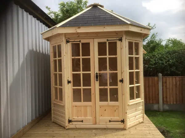 The Panoramic Octagon Summerhouse with traditional timber windows and paved base