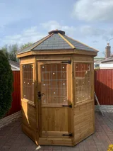 The Panoramic Octagon pavilion with felt shingle roof and panoramic panes