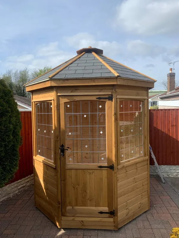 The Panoramic Octagon pavilion with felt shingle roof and panoramic panes