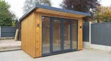 The Modern Pent Garden Room with dark fascia pent roof and panoramic UPVC glazing