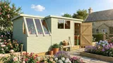 Sage green potting shed with door open, greenhouse section and tool storage visible