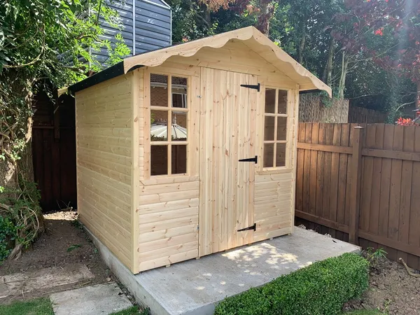 Traditional glazed garden shed with multi-pane windows and decorative apex fascia