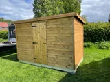 Bespoke pent roof tool shed alongside a boundary line with heavy-duty T-hinges
