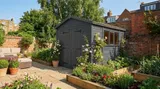 Custom-painted apex wooden workshop in a walled courtyard, tailored to the property