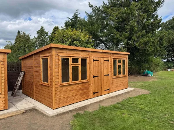 A spacious pent workshop with extensive window run for natural light