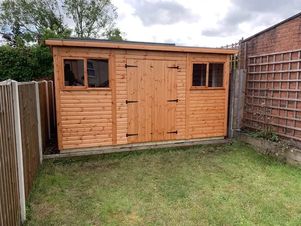 Modern pent workshop with a painted finish and multi-pane glazing