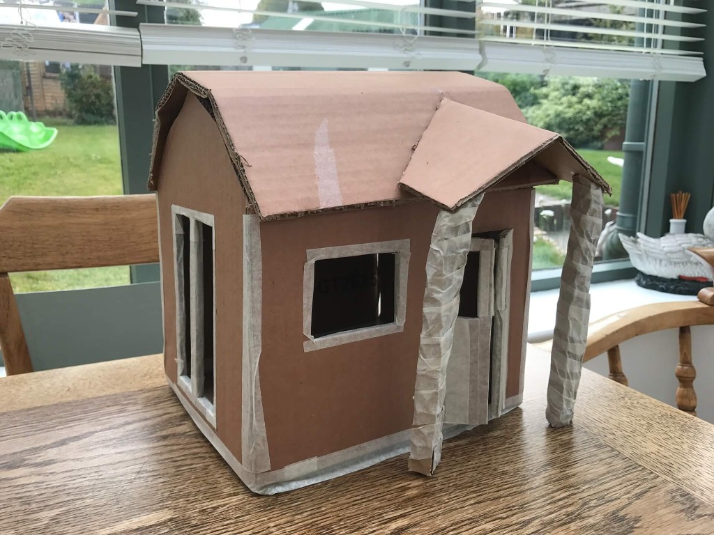 Customer's cardboard model of a garden building with gabled roof, porch and windows – bespoke design brought to our workshop